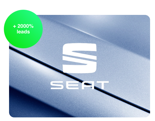 Close-up of a silver-blue SEAT car body with the SEAT logo and a +2000% leads badge
